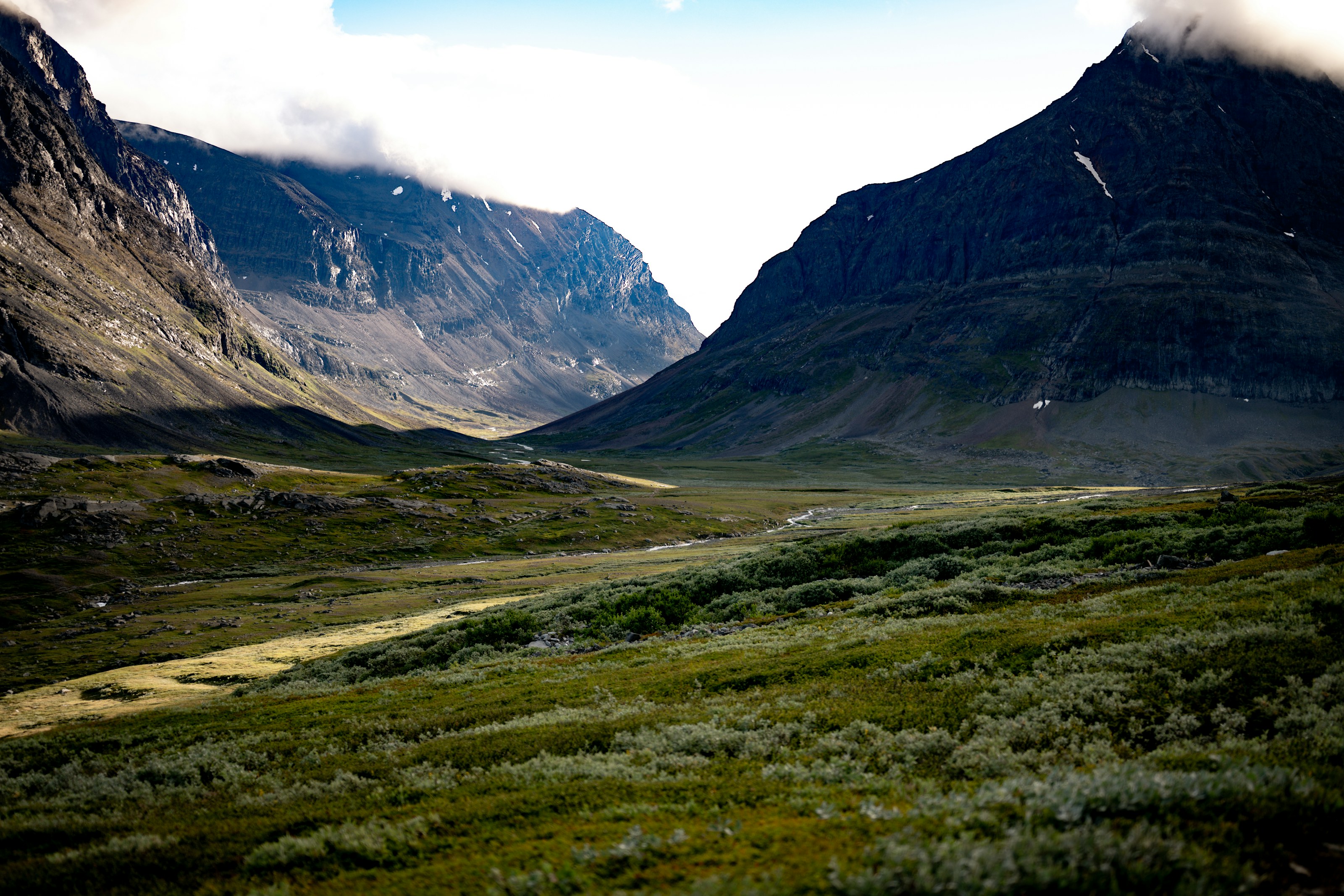 The broad glacial valley leading toward the Kebnekaise massif under heavy cloud