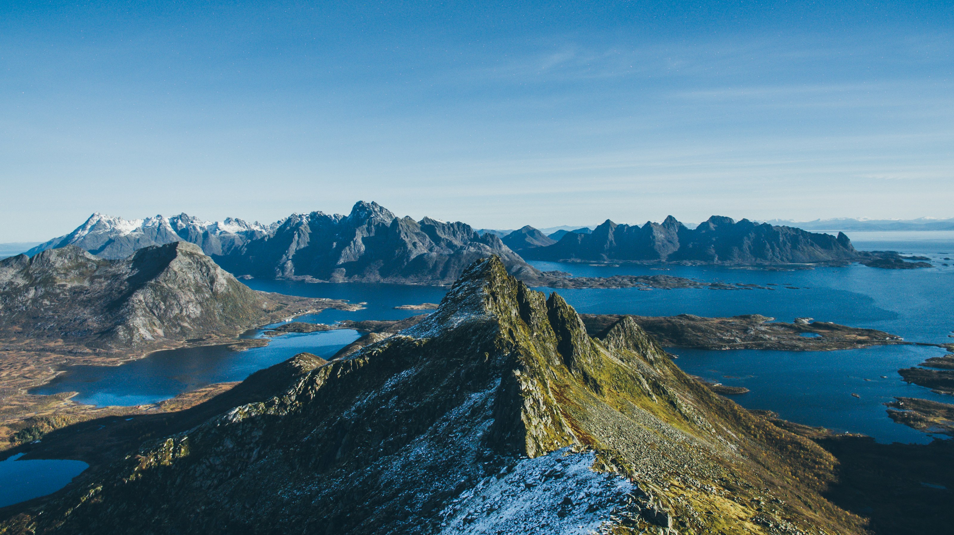 A ridge falling away to the sea in the Lofoten islands, cold blue water on both sides